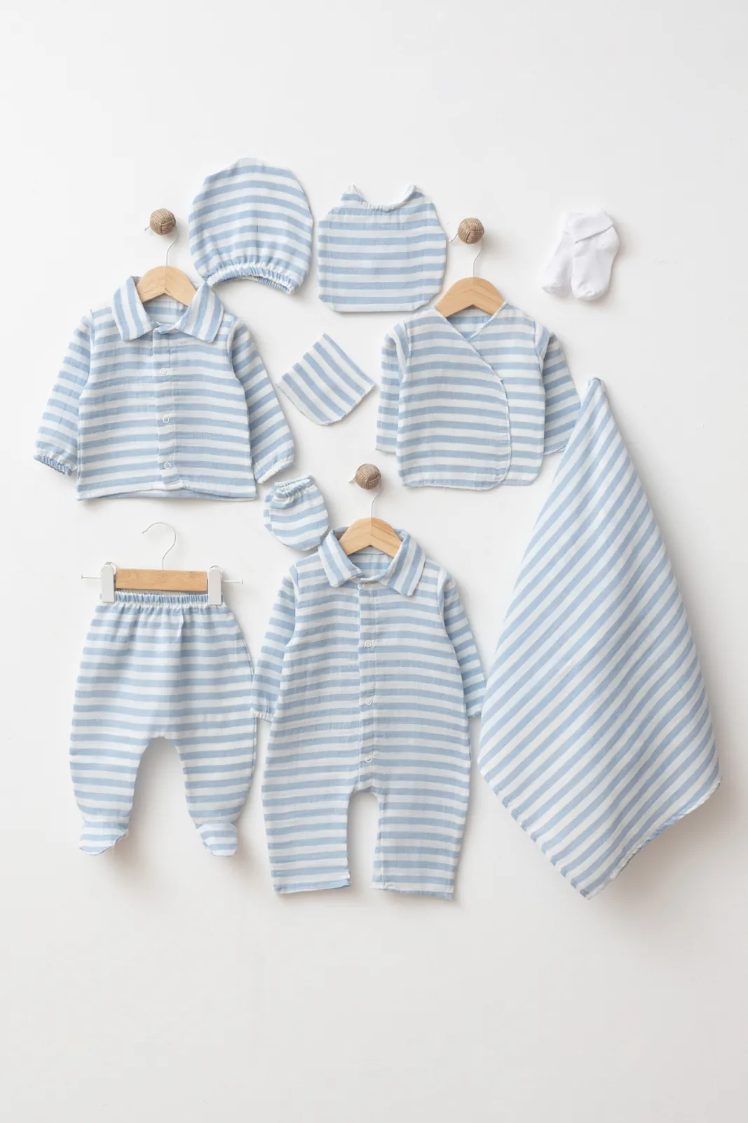 Wholesale 10-piece baby boy hospital set made from 100% cotton GOTS certified fabric including coordinated striped newborn clothing, blanket, hat, bib, mittens and socks.