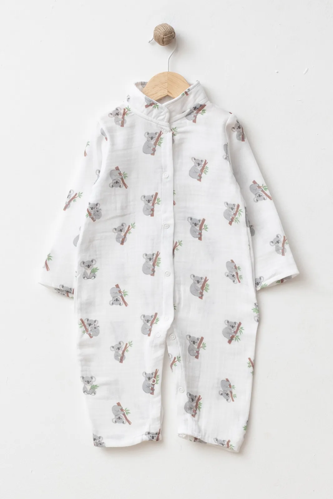 Wholesale GOTS-certified 100% cotton koala print long-sleeve baby romper with snap-button closure, supplied in a 4-piece size set for 3, 6, 9 and 12 months.